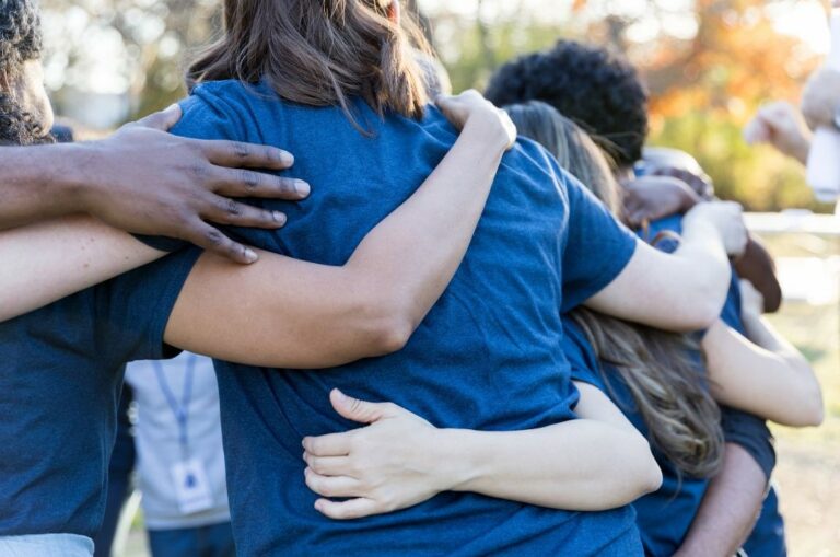 people in a team huddle