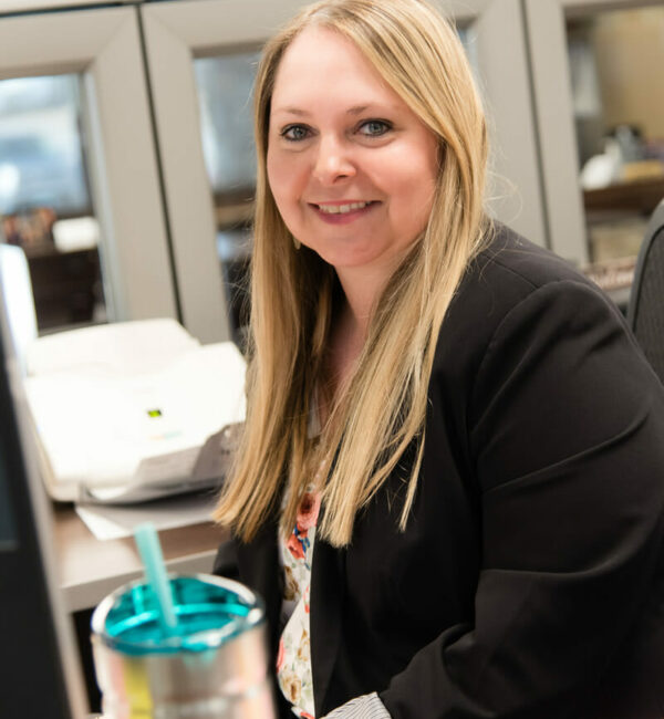 Laura Erdman sitting at her desk