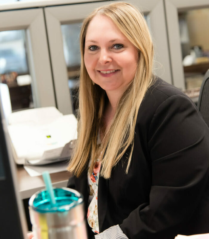 Laura Erdman sitting at her desk